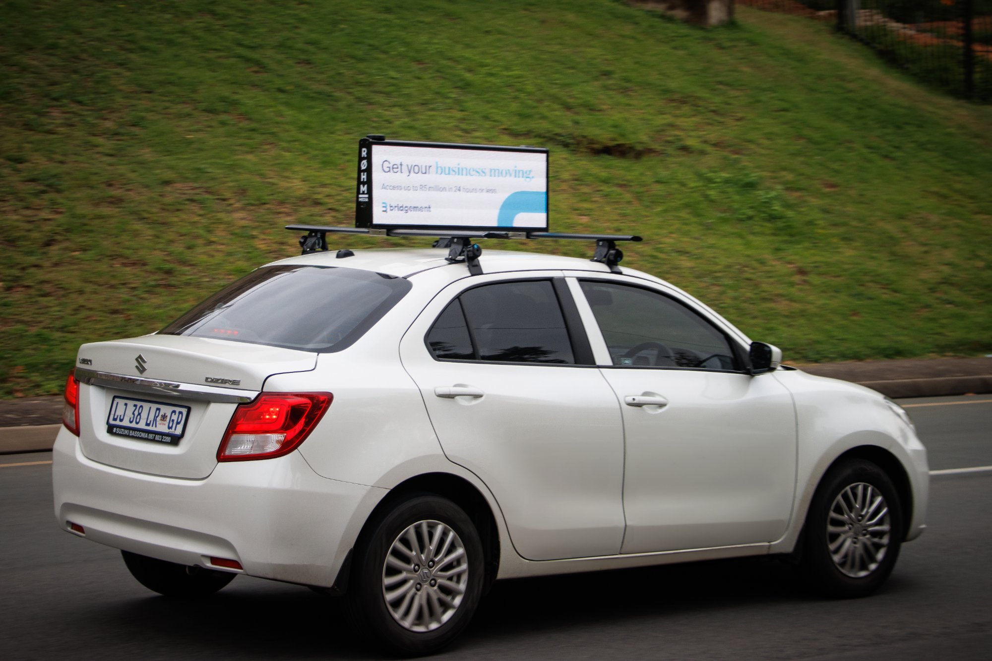 Bridgement business funding campaign on ROHM cartop billboard